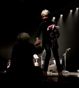 Fan presents Joan Baez flowers and thanks her for her stance on immigration at Lisner Auditorium in Washington DC